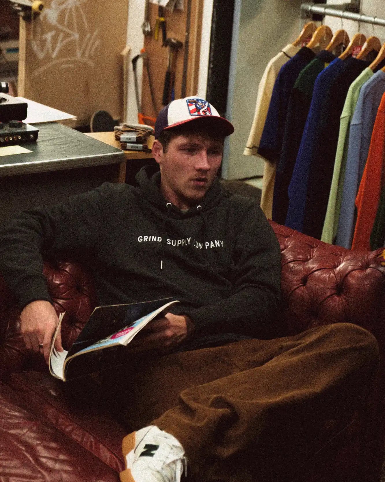 A worn leather couch in deep burgundy color.