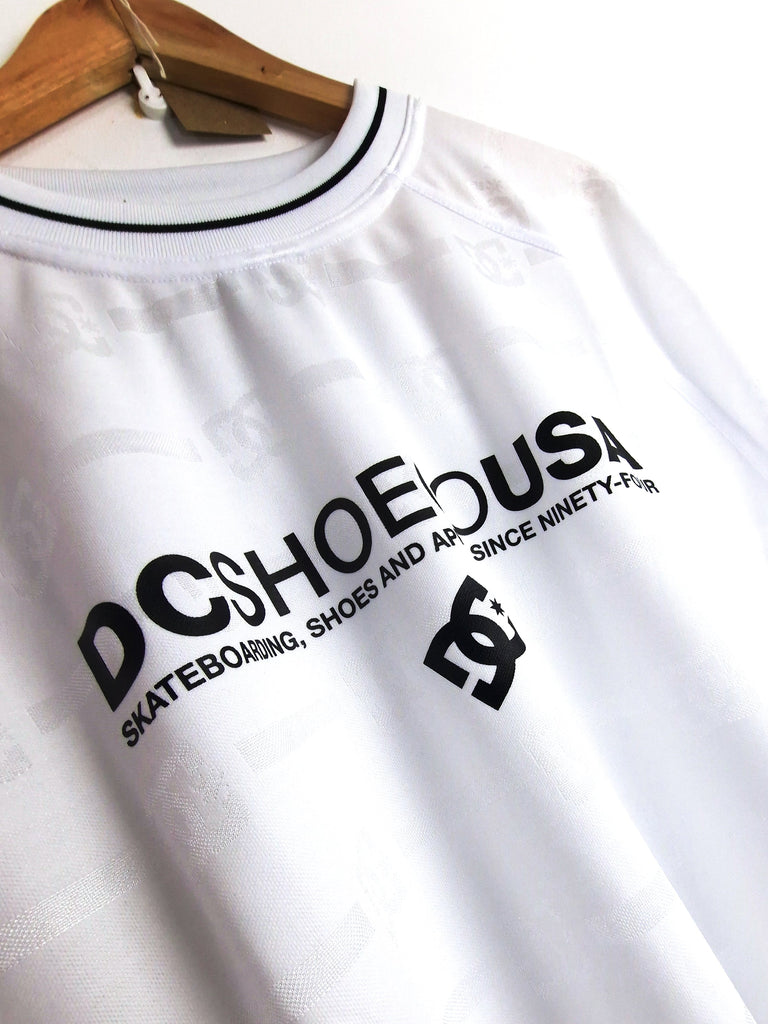 White t-shirt with black DC Shoes logo text and branding.