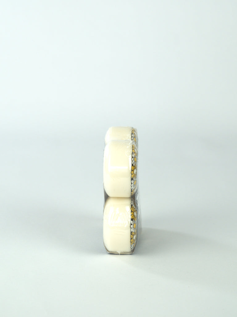 Two stacked white cylindrical Bones Wheels - X Formula V1 Standard, 99a, Pushing Up Daisies