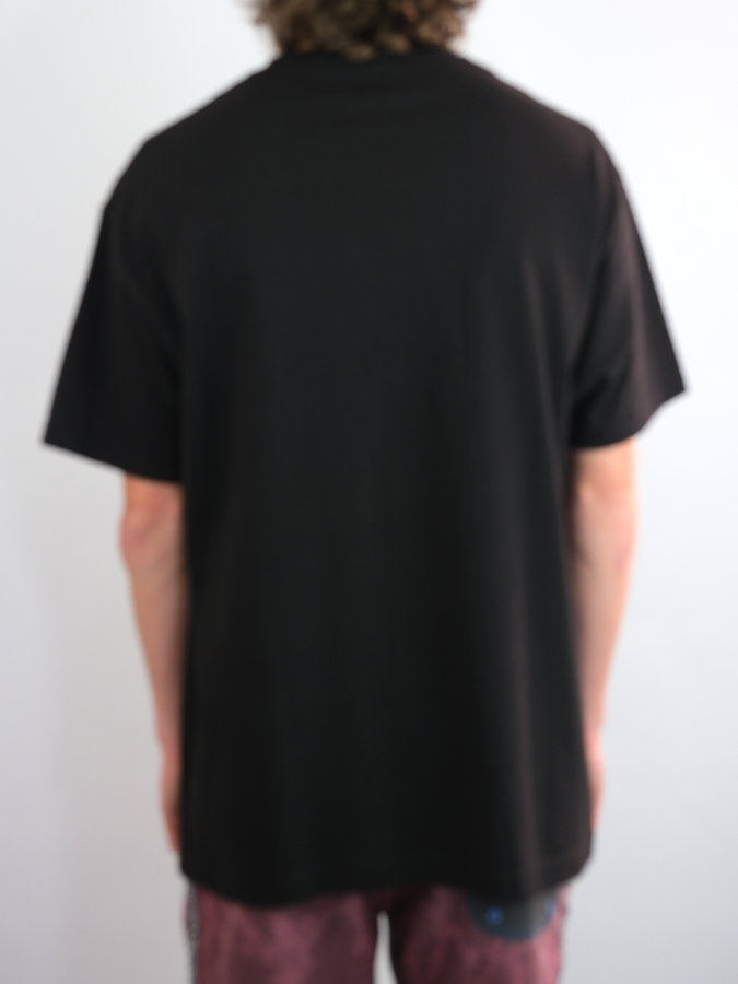 Black heavyweight cotton Buns T Shirt from Snack Skateboards worn by a person from behind