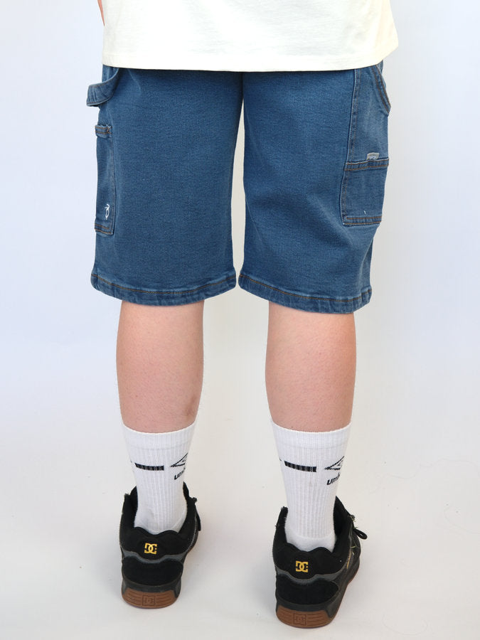 Pair of legs wearing blue denim shorts, white socks, and black shoes.