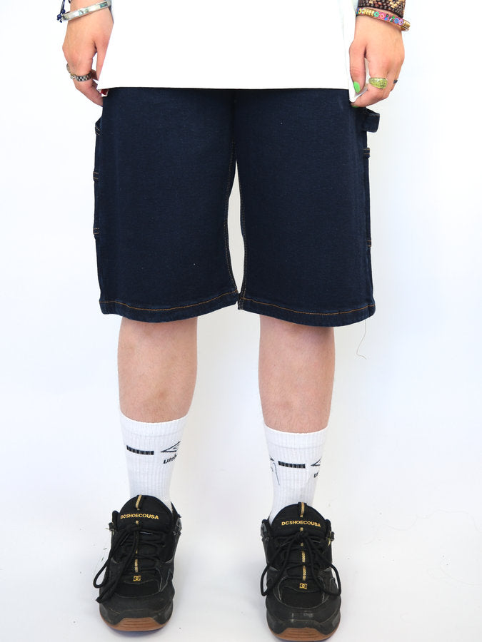 Navy blue knee-length shorts held by hands at the waistband.