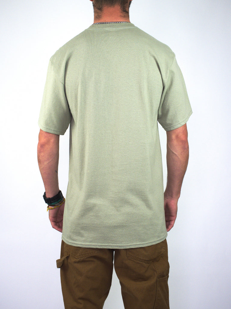 Plain laurel green Constanza tee worn by a person, showcasing Atlantis - Trinity design