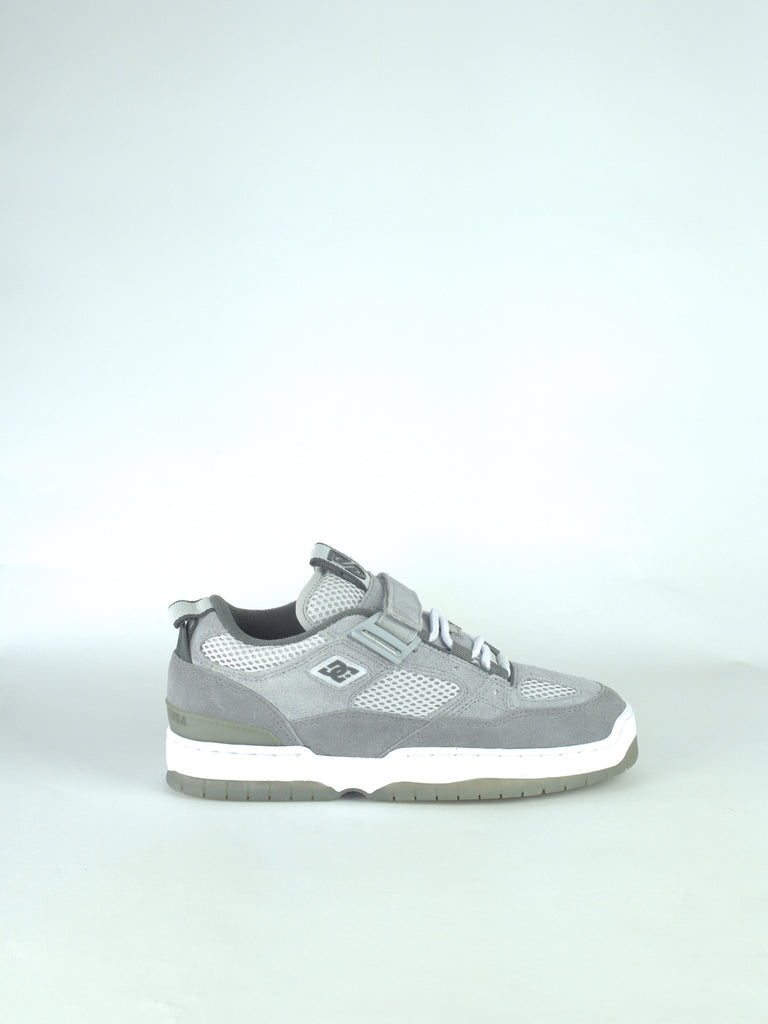 Gray and white athletic sneaker with laces and a distinctive logo on the side.