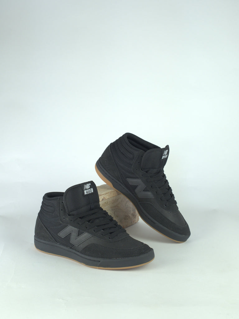 Pair of black high-top sneakers with the New Balance logo.