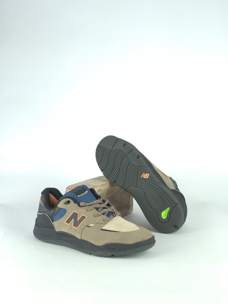 Pair of New Balance sneakers with beige, blue, and gray color accents.