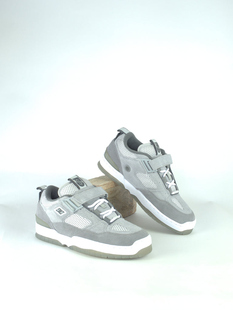 Pair of gray and white sneakers with velcro straps.