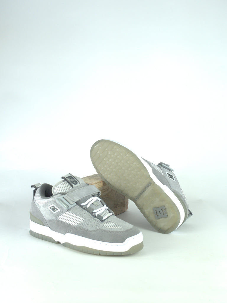 Pair of gray and white sneakers with velcro straps.