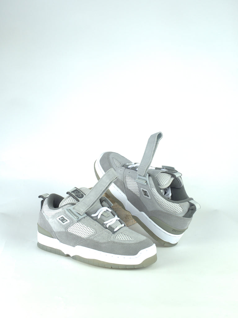 Pair of gray and white athletic sneakers with velcro straps.