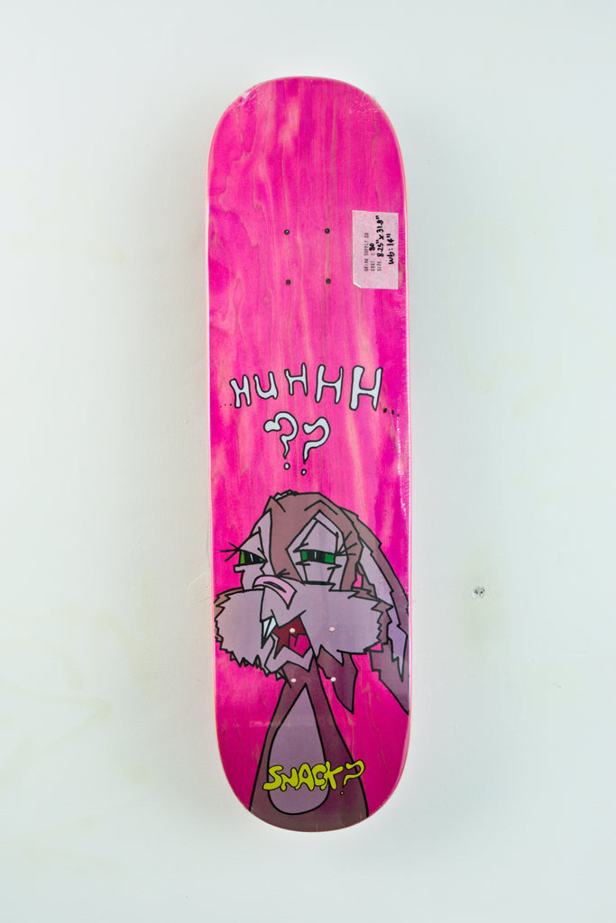 Bright pink Snack Skateboards Buns skateboard deck with cartoon character and text