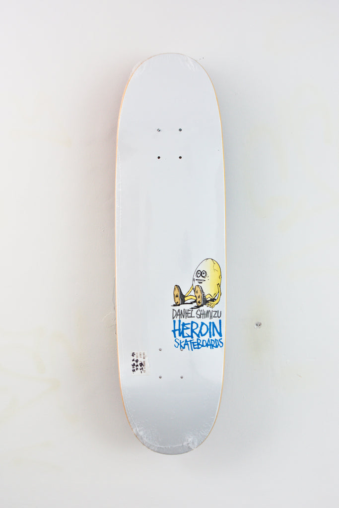 White Heroin Skateboards Daniel Shimizu Eggsperimental Skateboard Deck with cartoon illustration