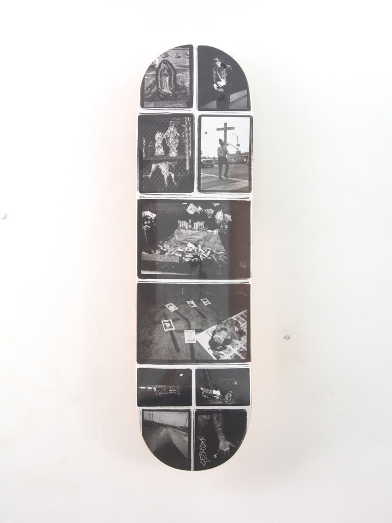 Skateboard deck featuring a collage of black and white photographs.