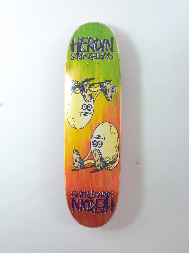 Colorful Heroin Skateboards Symmetrical Egg Rainbow Deck with cartoon graphics and text