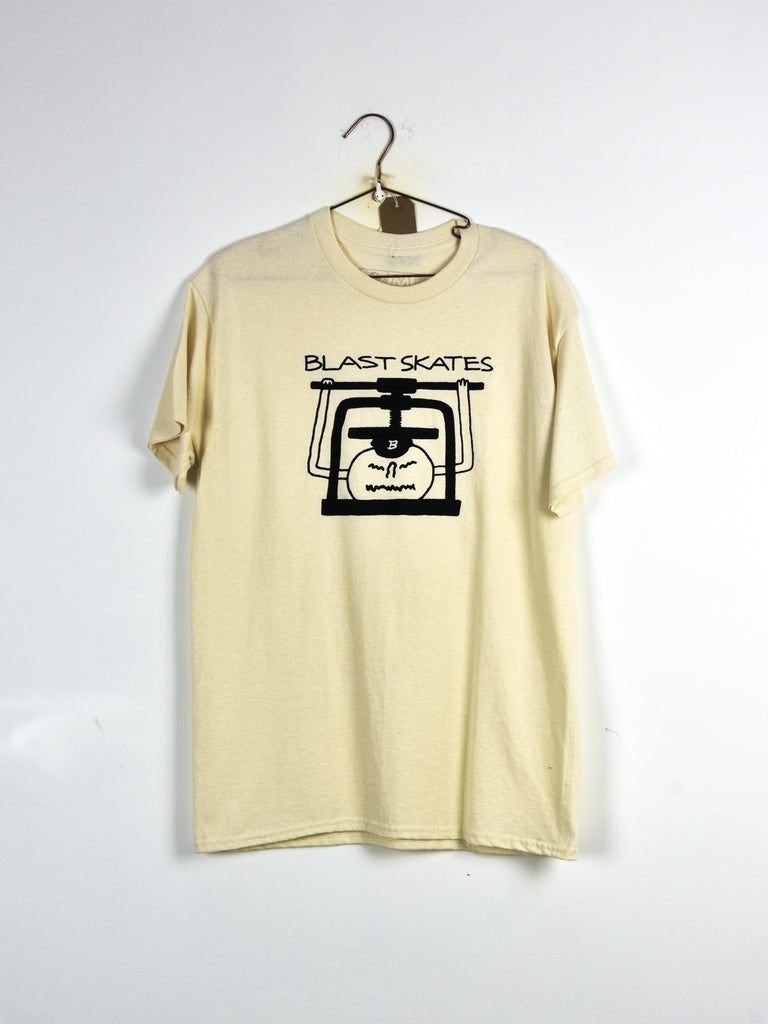 Cream-colored t-shirt with a ’Blast Skates’ logo featuring a geometric face design.