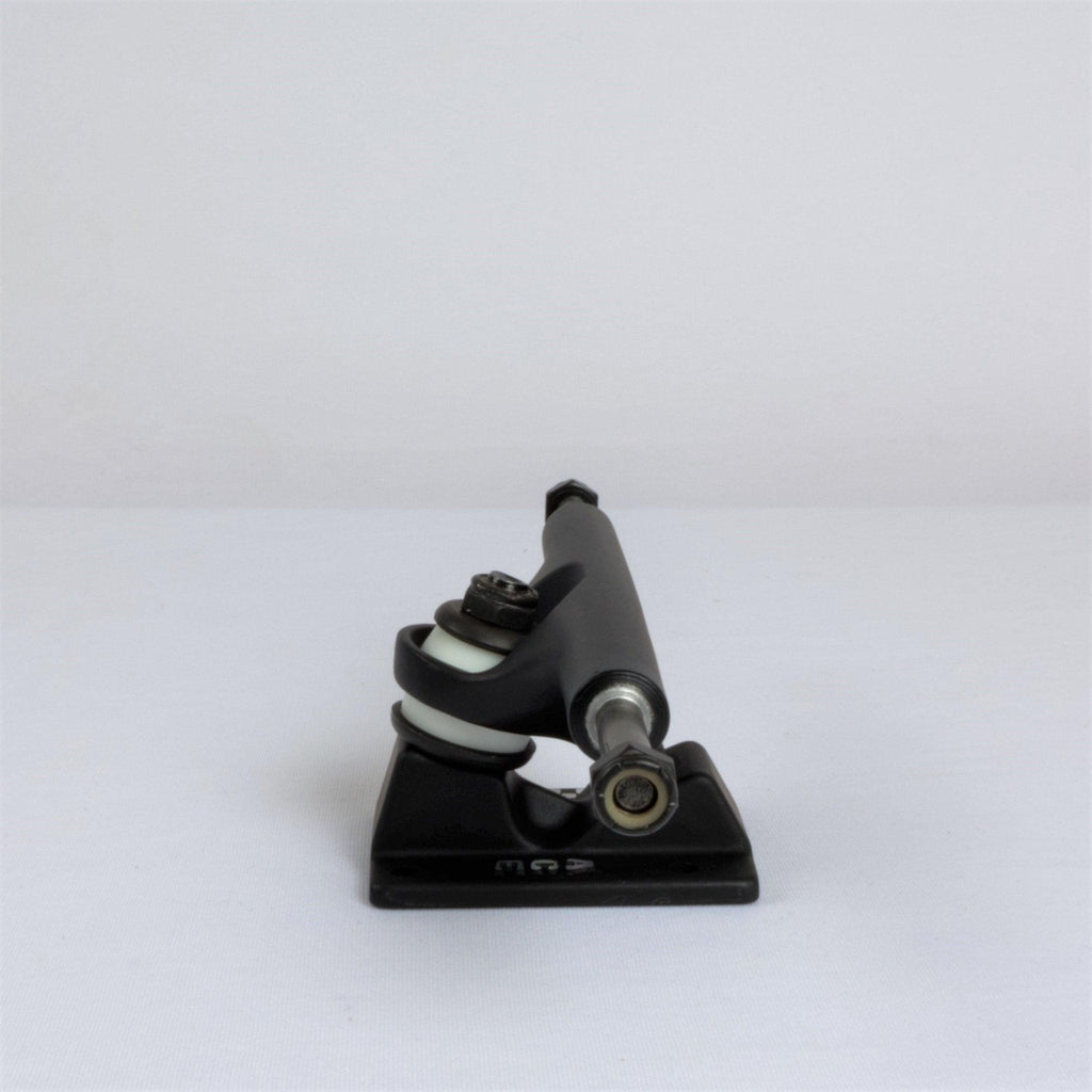 Skateboard truck, a metal component that attaches wheels to a skateboard deck.