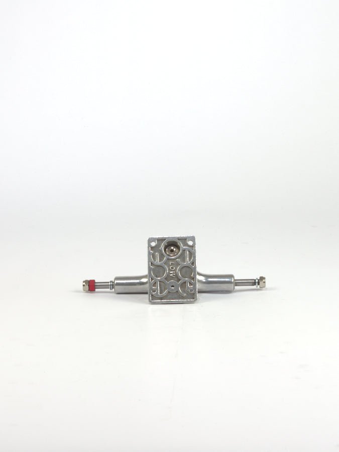 Skateboard truck made of metal with visible mounting holes and axle.