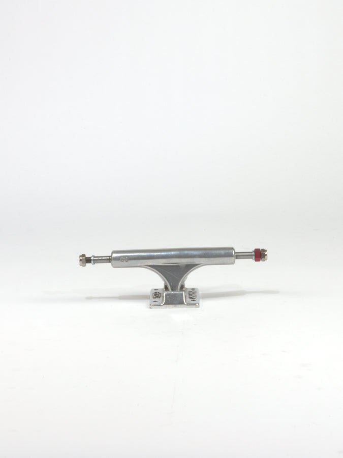Skateboard truck made of silver-colored metal with a red bolt.