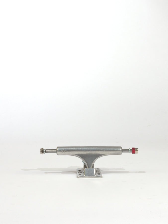 Skateboard truck made of silver-colored metal with a red bushing.