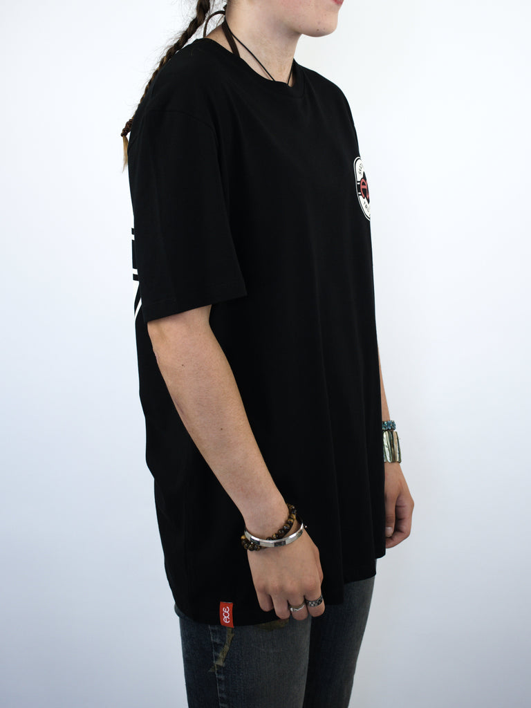 Black t-shirt with short sleeves worn by a person.
