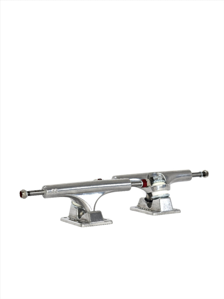 Pair of silver skateboard trucks with mounting hardware visible.