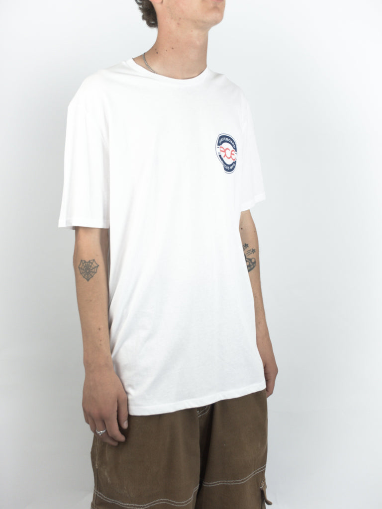 White Ace Trucks Seal T Shirt featuring a small blue logo patch on the chest