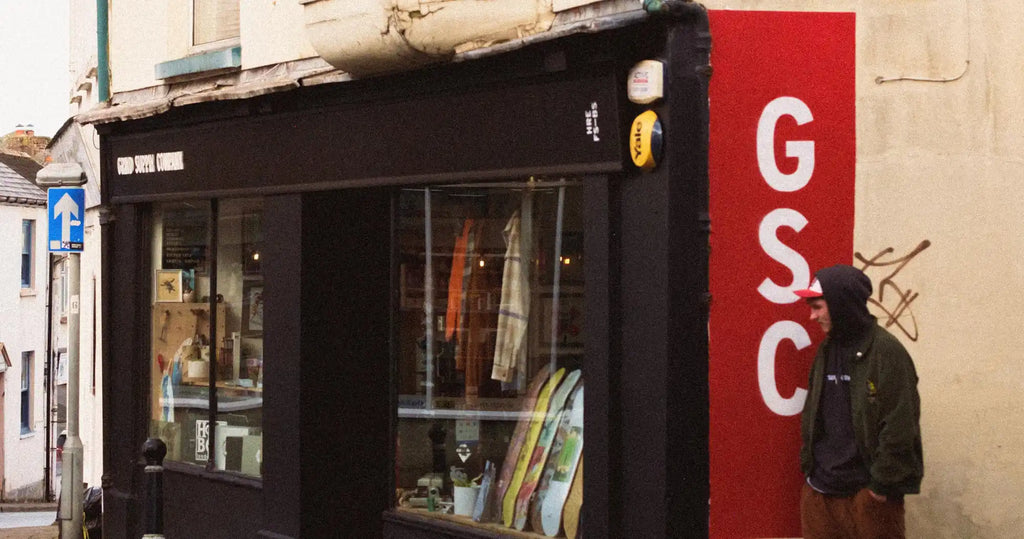 Black storefront with a red ’GSC’ sign on the side.