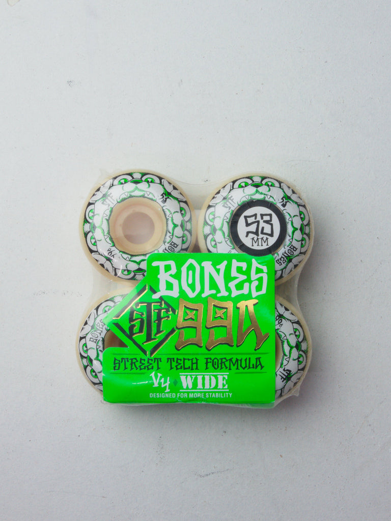 Set of four white and green Bones Street Formula skateboard wheels.