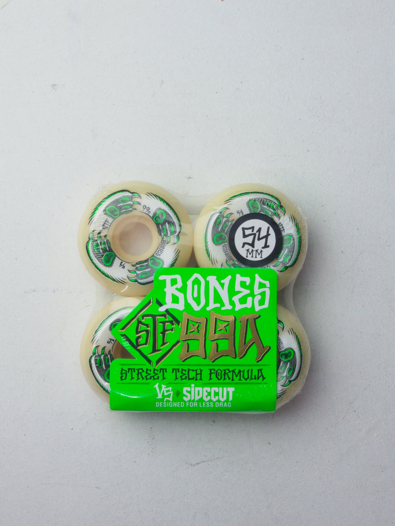 Set of four white skateboard wheels with green Bones SPF branding.