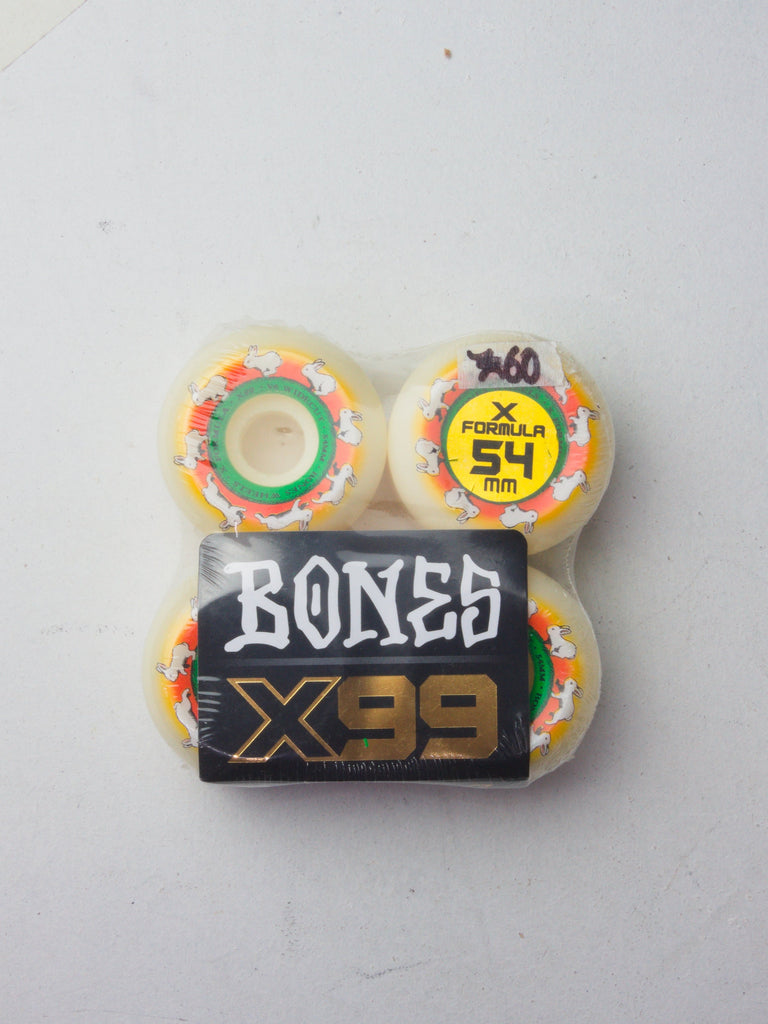 Set of four white skateboard wheels with colorful speckles and ’BONES X99’’ branding.