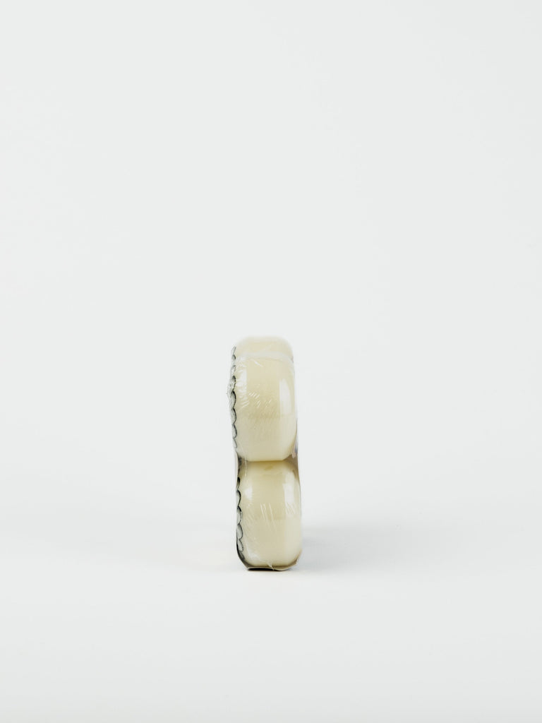 Wheel of soft white cheese with a dark rind.