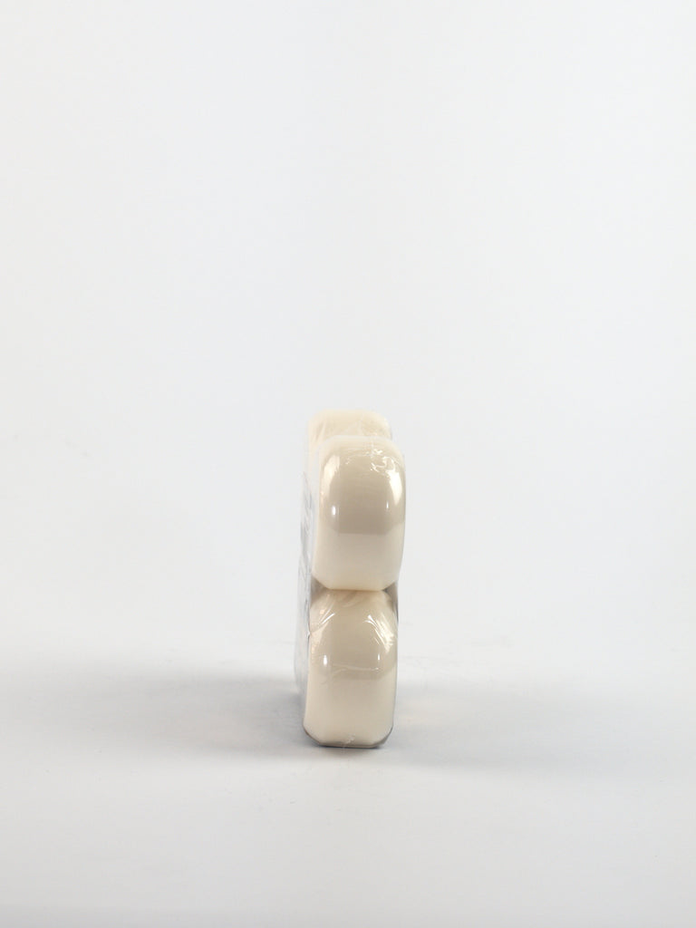 Two white pills or capsules stacked vertically.
