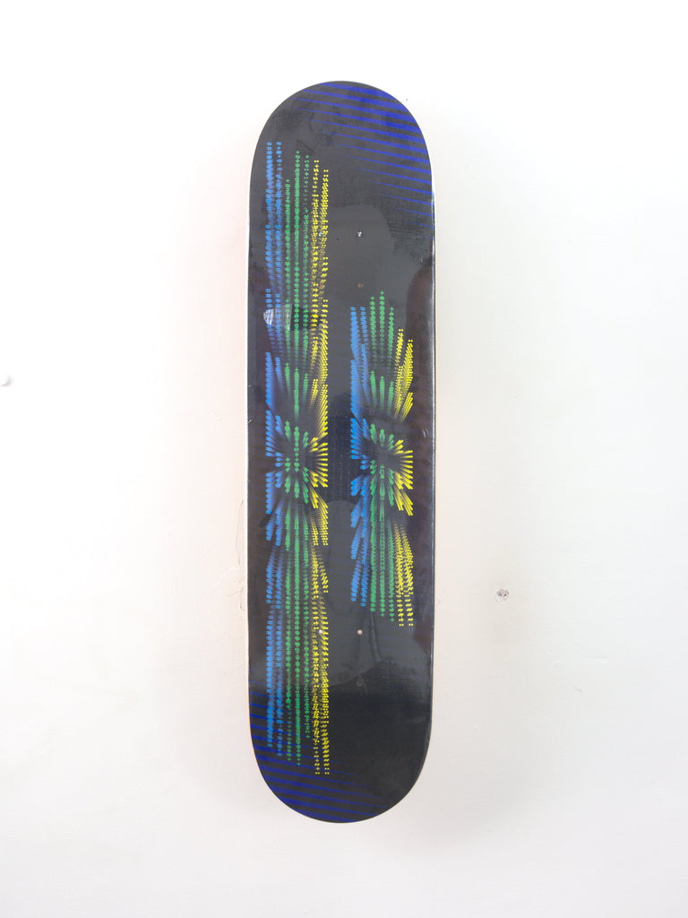 Skateboard deck with a colorful geometric design on its underside.