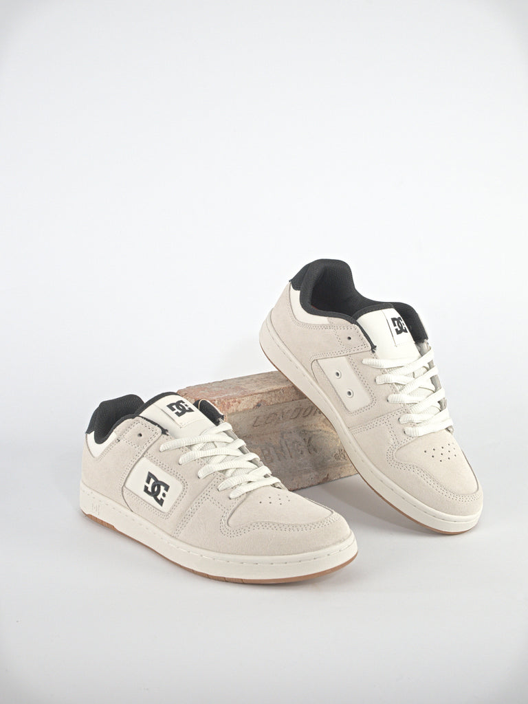 White DC Shoes Manteca 4 Footwear with black accents for casual skateboarding style