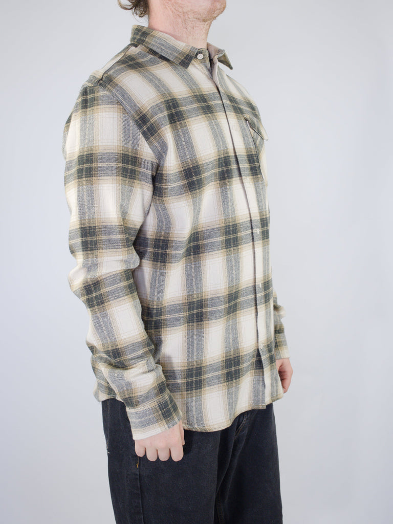 Plaid flannel button-up shirt in cream and gray tones.