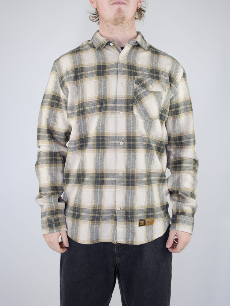 Plaid flannel button-up shirt in cream and gray tones.