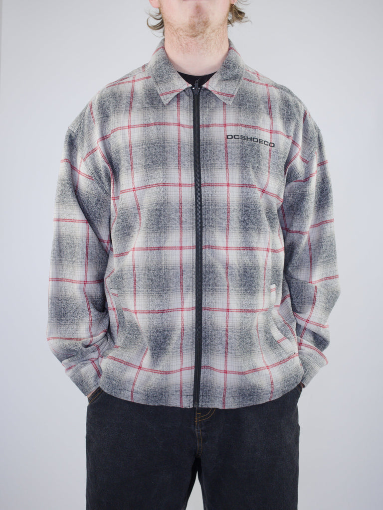 Plaid zip-up fleece jacket with gray and red pattern.