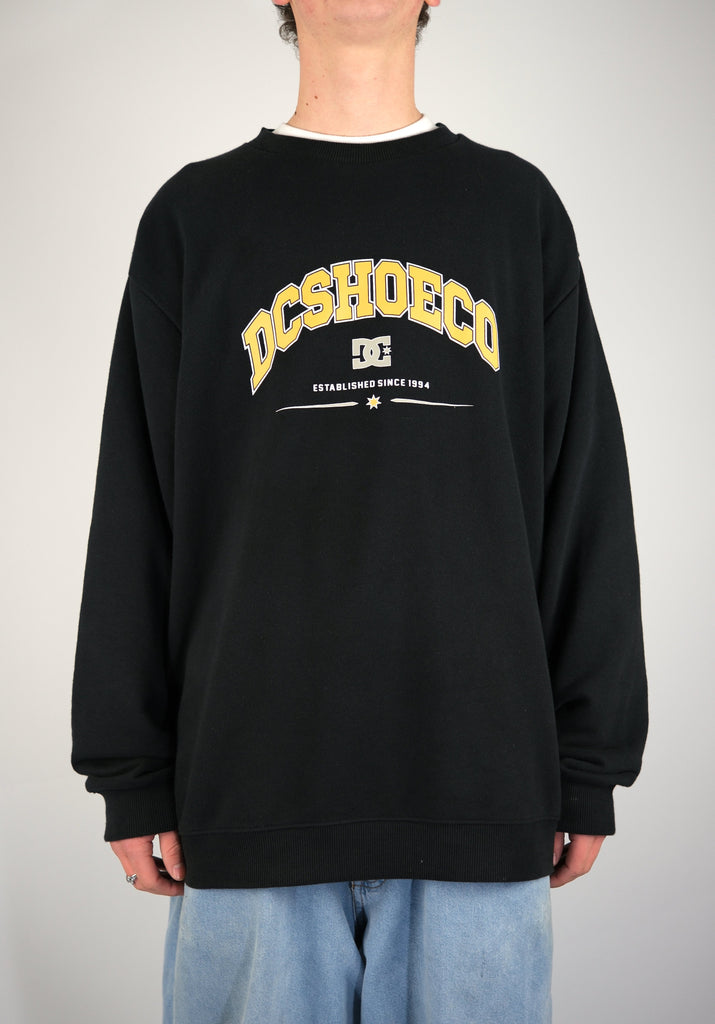 Black Terry Cloth Crew Sweatshirt featuring yellow DCSHOECO logo and text established since 1994