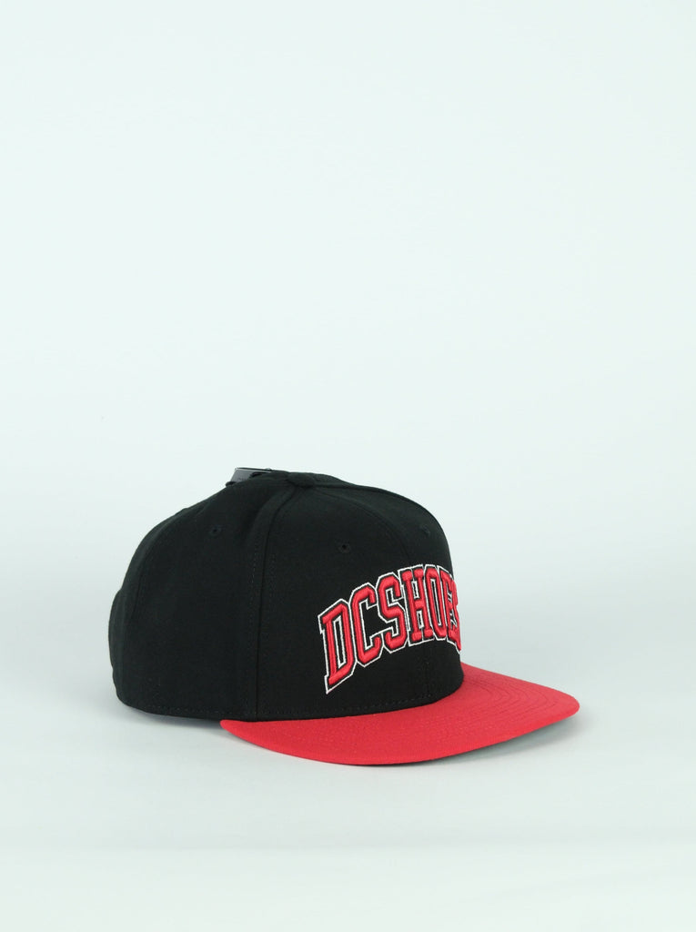 Black and red panel snapback cap featuring DC Shoes logo from the Shy Town Empire collection