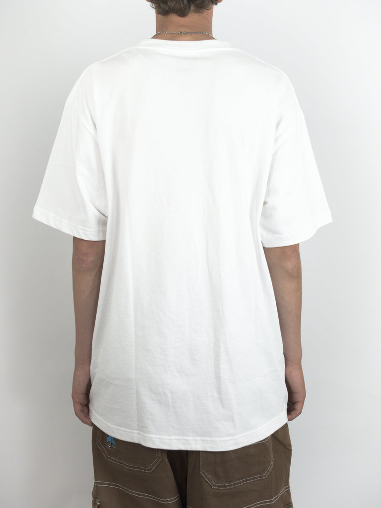 Plain white oversized t-shirt worn by a person featuring the Dc Shoes Super Tour Tee