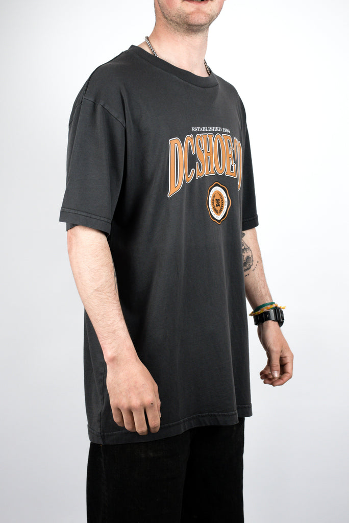 Black DC Shoes Tuition T Shirt featuring orange logo, perfect for shoes tuition enthusiasts