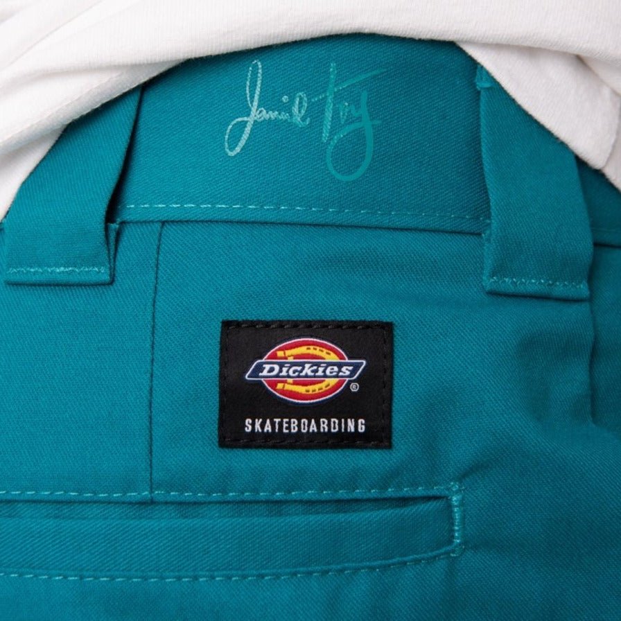 Teal Dickies skateboarding jacket with brand label paired with Fanfare Green Dickies pants