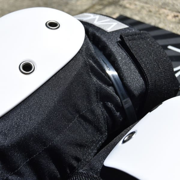Protective sports gear with black padding and white hard shell components.