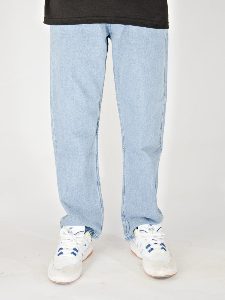 Light blue baggy fit denim jeans with white sneakers from Grind Supply Co’s Acid Wash Blue collection