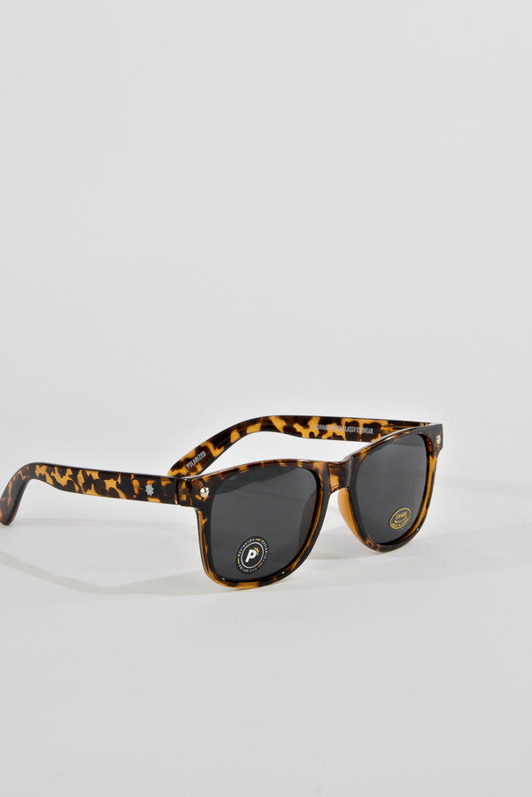 Pair of tortoiseshell-patterned sunglasses with dark lenses.