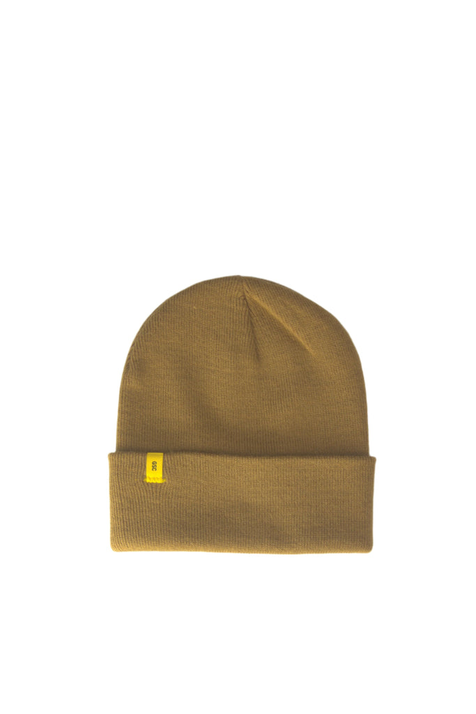 Tan knit beanie with a small yellow tag.