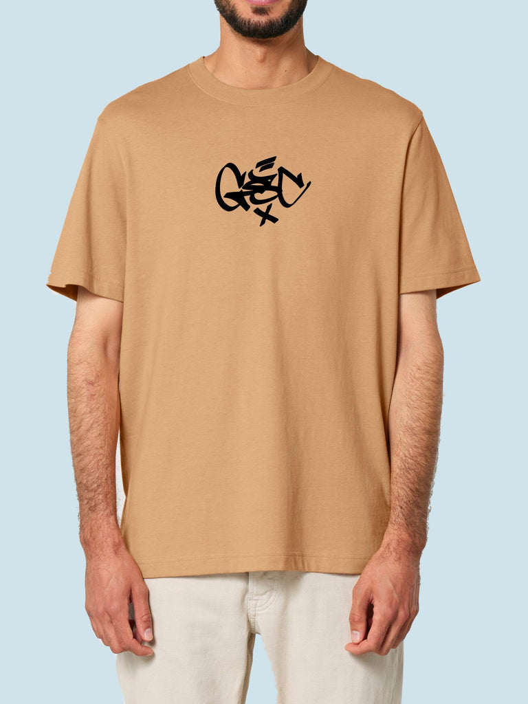 Tan t-shirt with a black abstract lizard-like design on the chest.