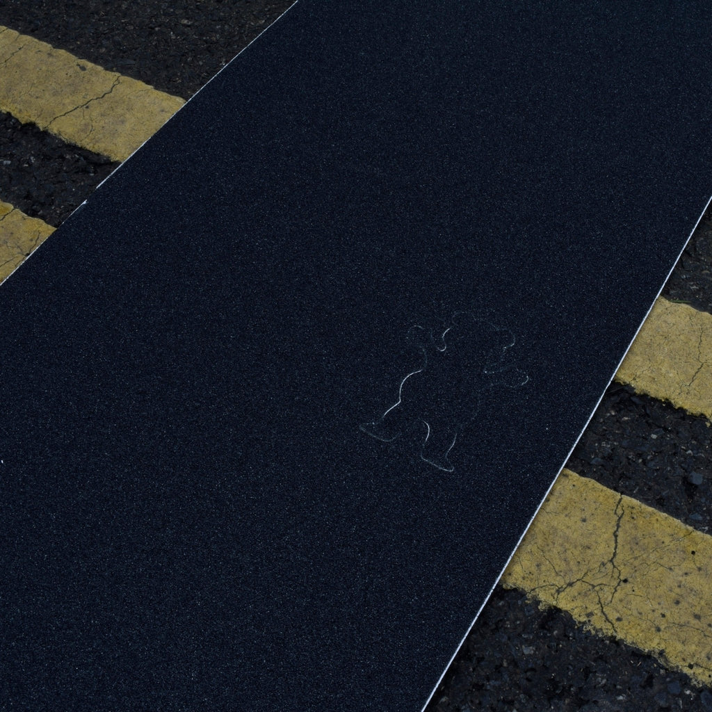 Chalk outline of a cat on asphalt with Grizzly Regular Cut 9” Grip Tape Sheet