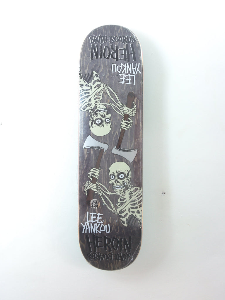 Black skateboard deck featuring skeleton artwork in white.