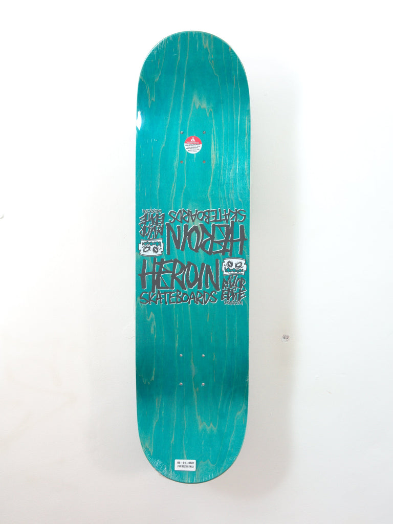 Turquoise skateboard deck with black text and graphics.