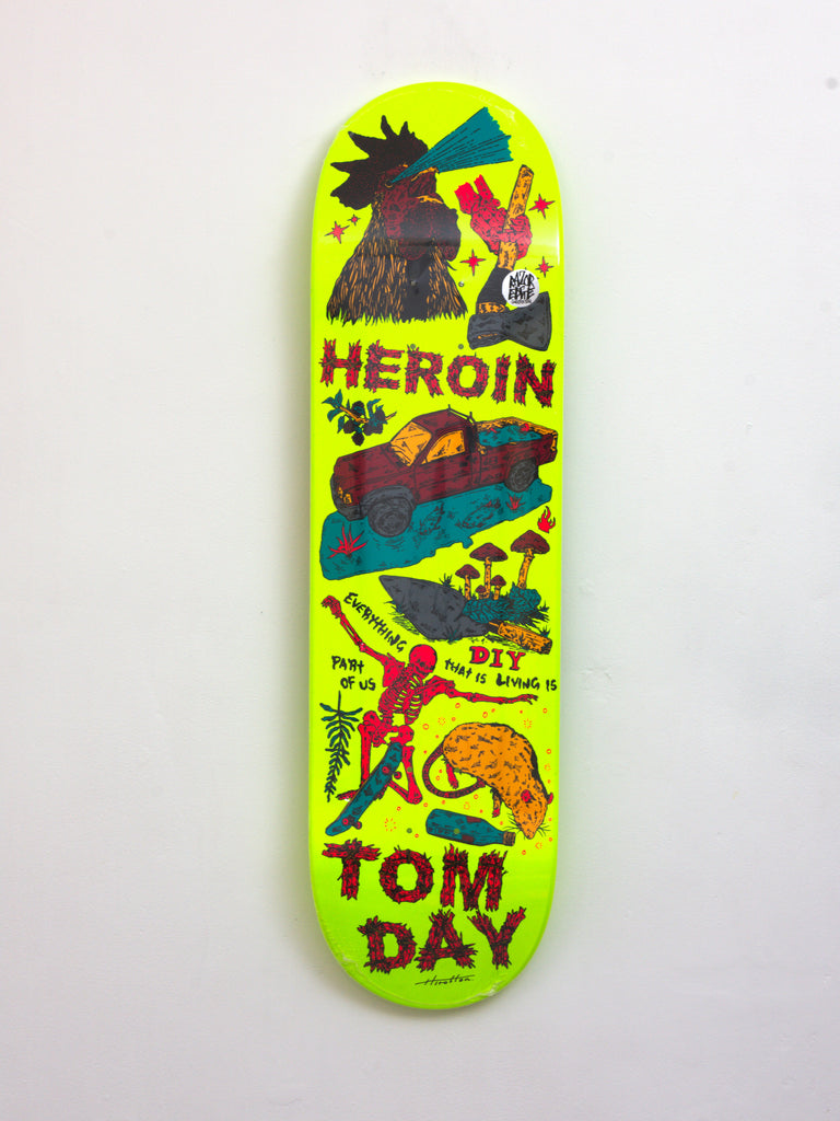 Neon yellow skateboard deck with colorful cartoon-style graphics and text.